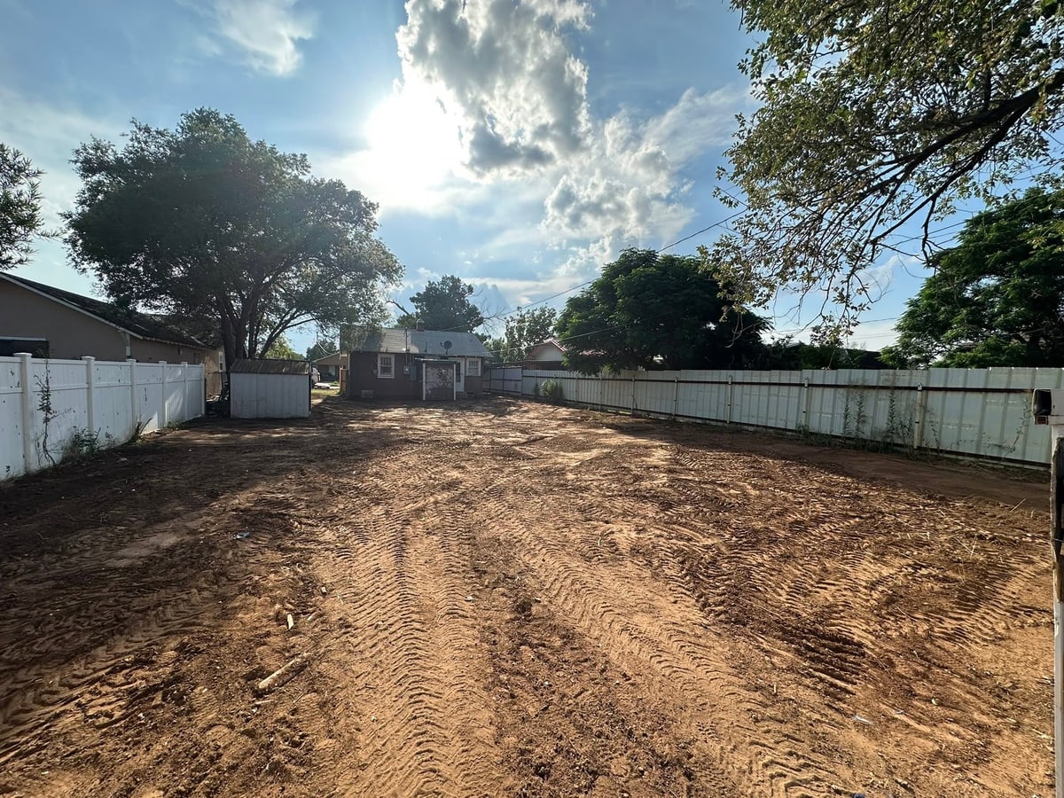 Back lot cleared and graded after a full property cleanout